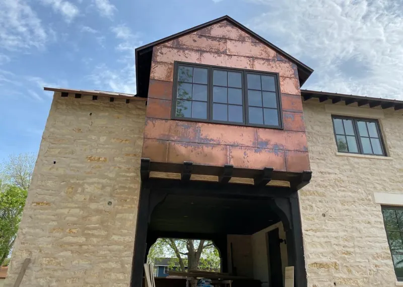 Copper metal panel facade on a stone building for Metal Roof Coating in Harrison